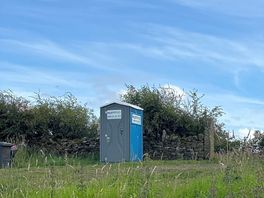 Situated at the entrance gate to the site, is the loo