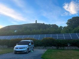 Van on the pitch, views of the tor in the background