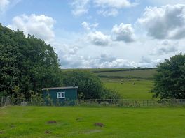 View of the sheep field and the shepherd hut