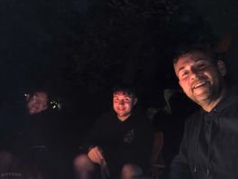 Glowing faces round the fire pit