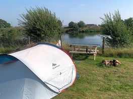 Tent-pitching plot overlooking fishery.