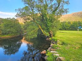 The river runs alongside the campsite.