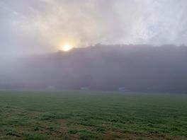 Sunrise on a misty morning over the campsite