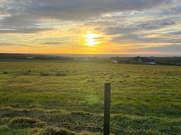 Sunset over the sea from the site