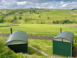 Emily & charlotte huts facing the view from their front.