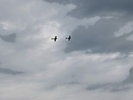 Spitfire and hurricane during a flyover at raf coningsby