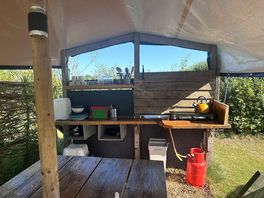 Kitchen fully stocked with utensils and a cooler