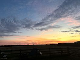 Sunset across camping field.