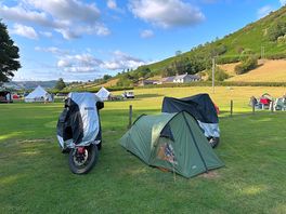 Our pitch at boatside with our motorcycles tucked in for the night.