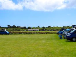 Very flat open field, surrounded by farmers field and local village cricket and football field