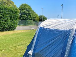 Our awning up plenty of room around and level clean grass .