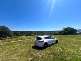 Car on site, stunning views