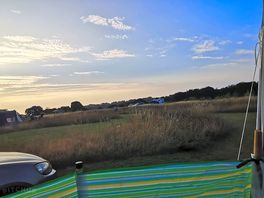 Hey field hideaway camp site at sunset