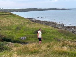 My son walking the coast