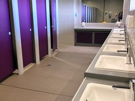 Toilet block. the showers are in a row behind the tow of toilets.