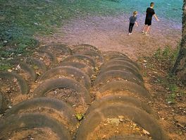 Tyre steps to lower level with a small slope. other way is a sloped walk way with rope alongside