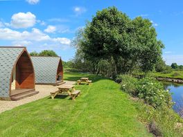 Riverside pods with picnic benches
