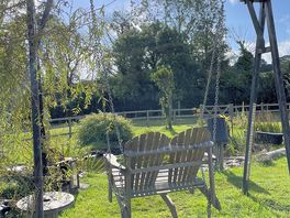 Swinging chair by the pond
