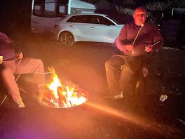 Our caravan on a d pitch and nighttime by the fire 🔥 with marshmallows
