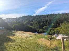 View looking down the field towards the pitches and lake
