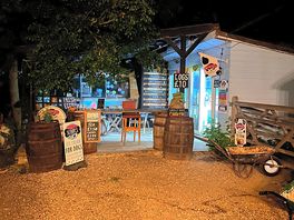 Shop lit up at night.