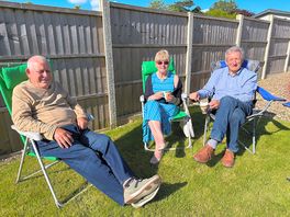 Friends, enjoying the sunshine, whilst sitting outside our camper van, on the pub site.