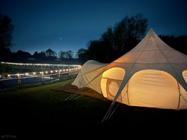 A photo of the tent we stayed in facing the pond. all lit up and pretty.