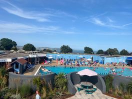 Outdoor pool from terrace, sea in background