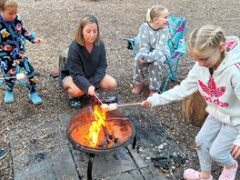 Around the fire pit burning marshmellows.