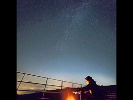 Milky way galaxy under a warm fire