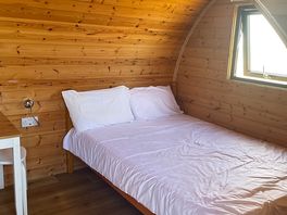 Inside camping pod, double bed.
