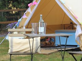 Table and chairs outside each tent