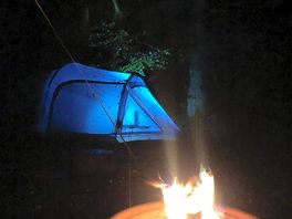 Fire by the tent at night