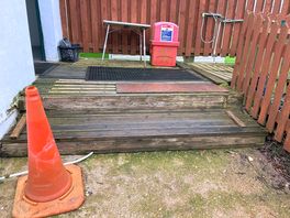 Steps up on decking to entrance of toilet/shower block