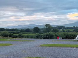 Tiered pitches in second field with views across to snowdonia. evening shot.