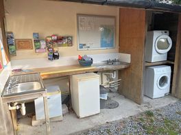 Communal washing area inc fridge washing machine and tumbler available at a charge