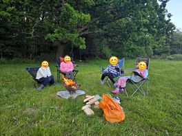 Eating marshmallows around the camp fire.