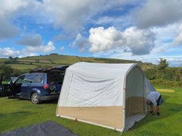 Car camper all set up top of the hill