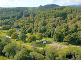 Aerial view of the site's forest setting