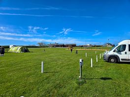 Standard campervan pitches with play area in background.