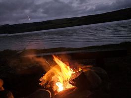 Fire roaring in the fire put next to the loch