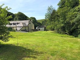 Grass pitches along Ashcombe water