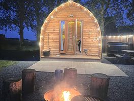 The log cabin with pretty lights whilst having a fire