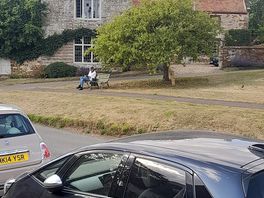 Wife reading on the village green