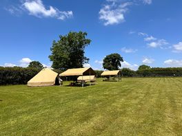 Our bell tent with seating area and stove just outside