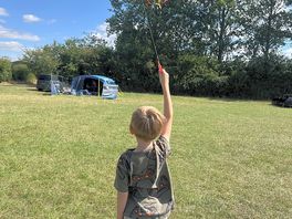 Our tent set up with the play area behind the hedges for easy access. kite flying was ace!