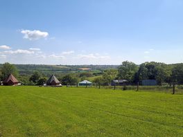 View from the camping area, overlooking the lodges and the farm/hills beyond.