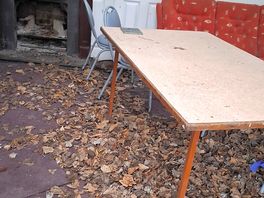 Outdoor dining area, complete with rotting decaying sofas