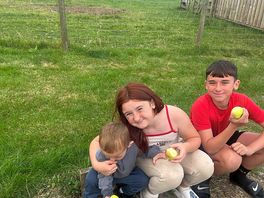 Happy kids eating apples off the tree
