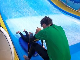 Ben teaching mydaughter on the surf simulator
